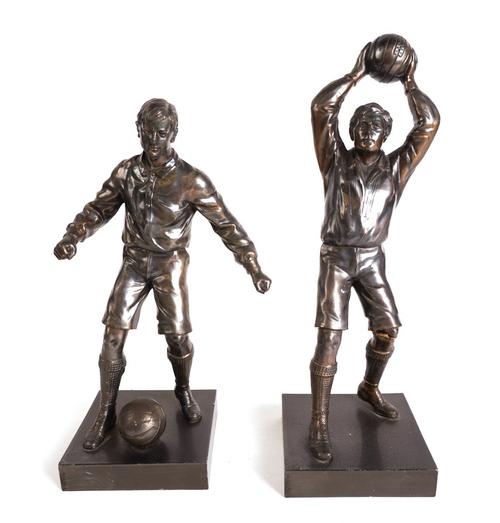A PAIR OF SILVERED METAL FIGURES FOOTBALLERS AND TWO OTHER AMERICAN BRONZED METAL FIGURES OF SPORTS MEN (4)
