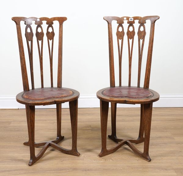 IN THE MANNER OF VOYSEY; A PAIR OF ARTS AND CRAFTS OAK SIDE CHAIRS