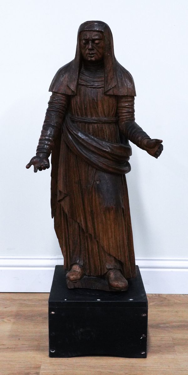 A NORTH EUROPEAN CARVED WALNUT FIGURE OF A WOMAN IN A HEADDRESS