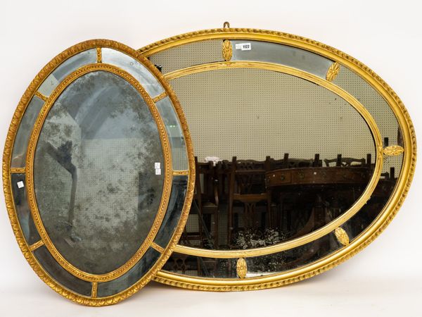 AN EARLY 20TH CENTURY GILT FRAMED OVAL MARGINAL MIRROR (2)