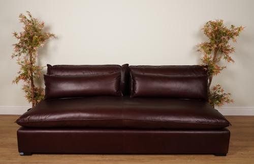 A LARGE BROWN ESPRESSO ARMLESS LEATHER SOFA