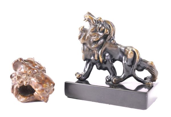 A BRONZE MODEL OF A LION AND A BRONZE LION HEAD, POSSIBLY A DOOR KNOCKER (2)