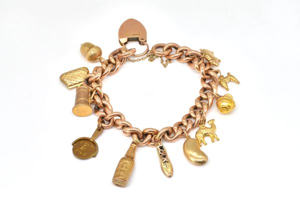 A GOLD CURB LINK CHARM BRACELET