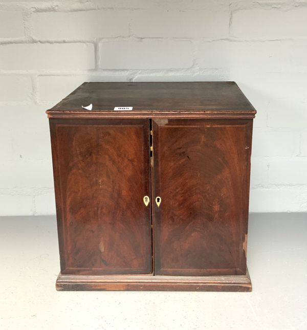 A MAHOGANY TWO DOOR COIN CABINET