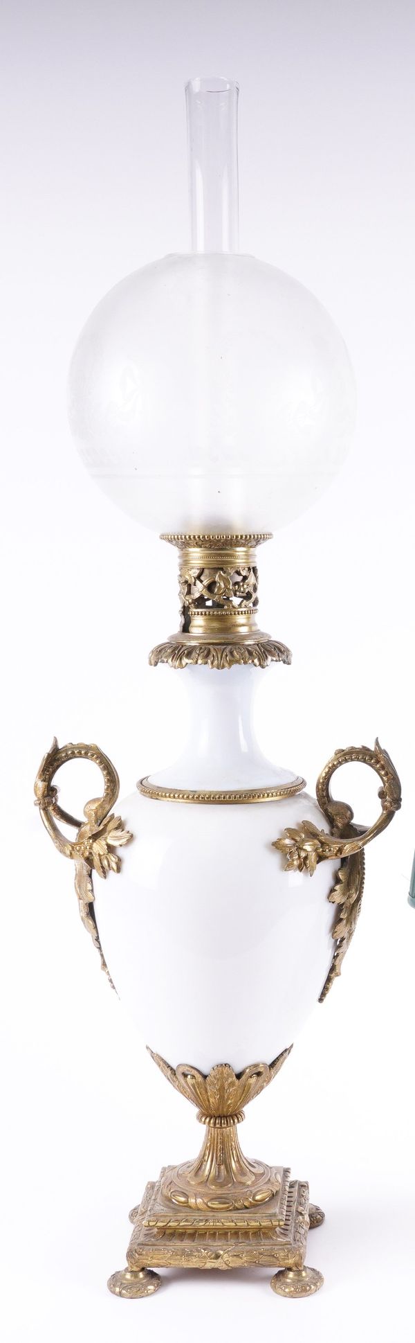 AN OPALINE GLASS AND GILT-METAL MOUNTED CONVERTED OIL LAMP