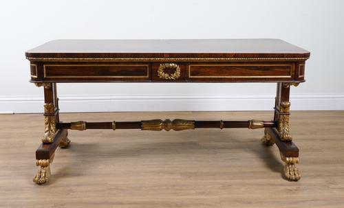 A REGENCY PARCEL-GILT GESSO MOUNTED ROSEWOOD FREESTANDING CENTRE WRITING TABLE