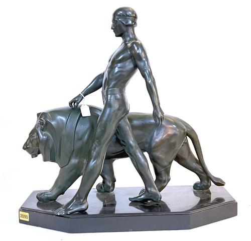 CAST AFTER A MODEL BY MAX LE VERRIER; AN ART DECO BRONZED METAL MODEL OF THE WALKING NUDE AND LION
