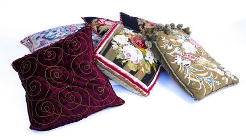 A GROUP OF SIX CUSHIONS INCLUDING FOUR WOOLWORK EXAMPLES (6)