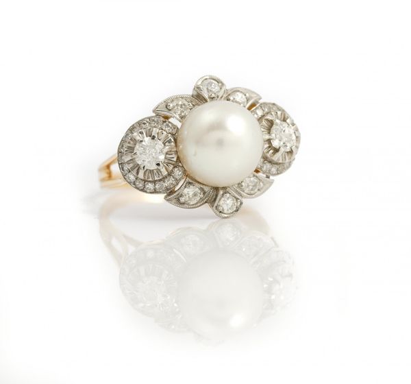 A cultured pearl and diamond-set dress ring, of lozenge design, the central cultured pearl within a surround of pave-set circular and mine-cut...
