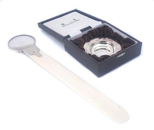 A SILVER MOUNTED IVORY MAGNIFYING GLASS/ PAGE TURNER AND A SILVER ARMADA STYLE DISH (2)