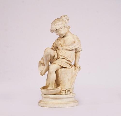 AN ITALIAN CARVED MARBLE FIGURE OF A SEATED YOUNG GIRL