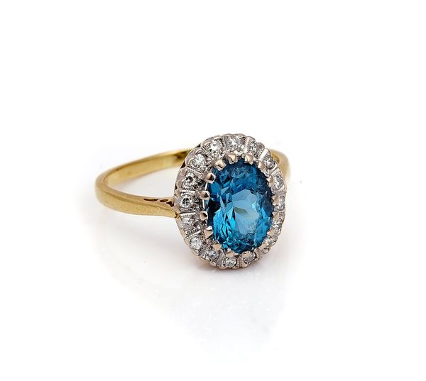 AN 18CT GOLD, BLUE TOPAZ AND DIAMOND OVAL CLUSTER RING