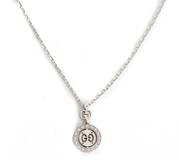 A Gucci white gold and diamond set pendant necklace, the front with a circular drop mounted with a surround of circular cut diamonds, the oval link...