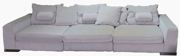 A LARGE LIGHT GREY VELVET UPHOLSTERED SOFA