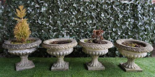 A SET OF FOUR RECONSTITUTED STONE SEMI-FLUTED JARDINIERES (4)