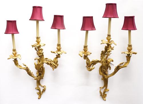 A PAIR OF FRENCH LOUIS XV STYLE ORMOLU THREE BRANCH WALL LIGHTS (2)