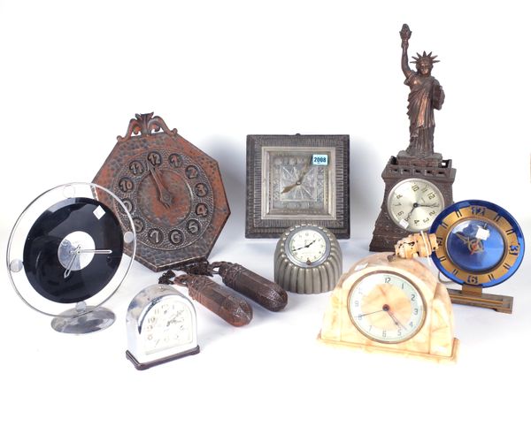 SEVEN 20TH CENTURY CLOCKS, INCLUDING ARTS AND CRAFTS EXAMPLES AND AN EARLY AMERICAN SOUVENIR CLOCK