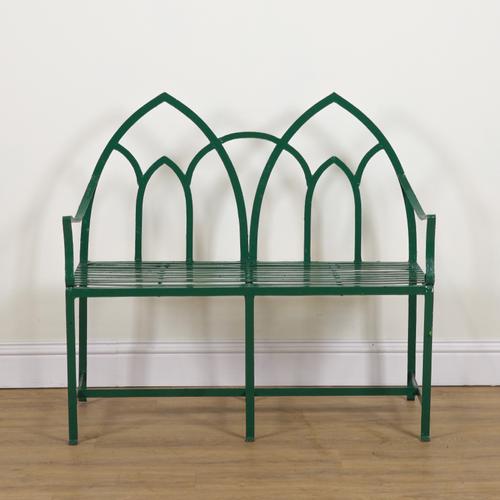 A REGENCY STYLE GREEN PAINTED STRAP IRON GARDEN BENCH