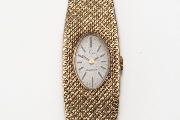 A LADY'S GOLD OMEGA WATCH