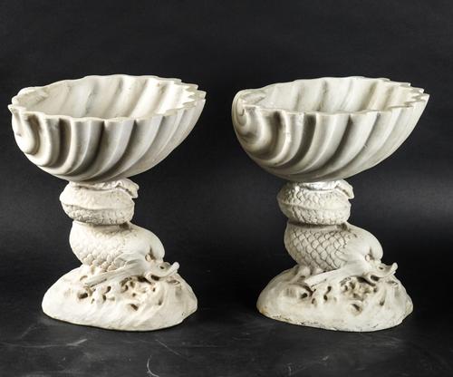 A PAIR OF WHITE COMPOSITE DOLPHIN NAUTILUS DISHES AND A SHELL COMPONENT (3)