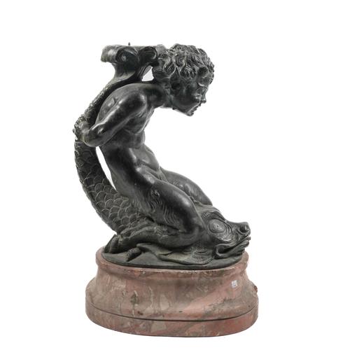 A BRONZE FAUN RIDING A DOLPHIN ON A LARGE MARBLE FOOT