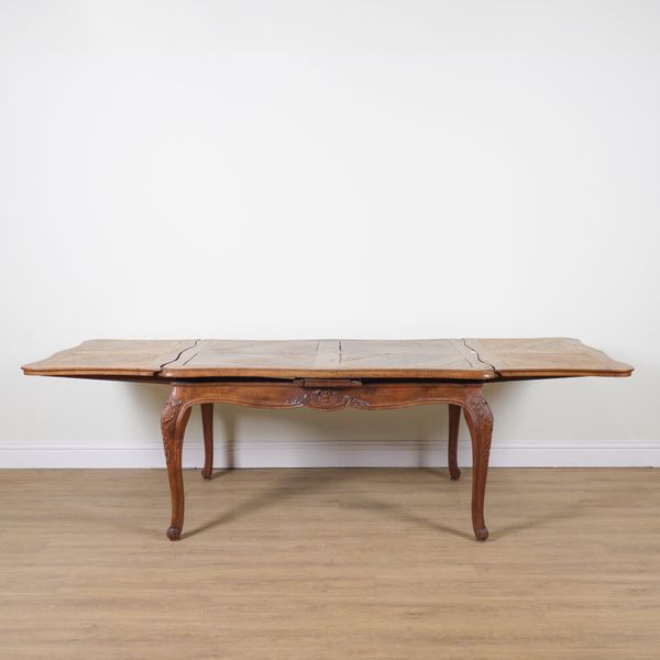 A 19TH CENTURY FRENCH OAK DRAW LEAF EXTENDING DINING TABLE