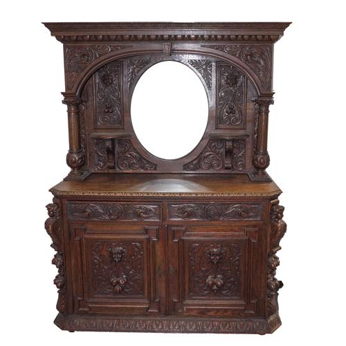 A VICTORIAN CARVED OAK MIRRORED BACK SIDEBOARD