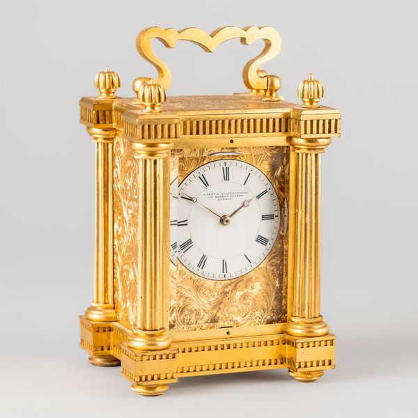 AN ENGLISH ENGRAVED ORMOLU CARRIAGE TIMEPIECE