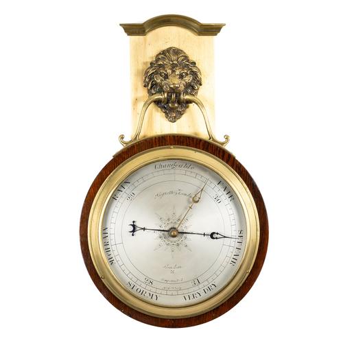 AN OAK AND BRASS ANEROID BAROMETER