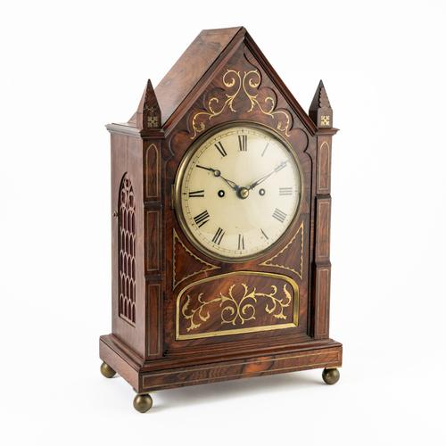 A LATE REGENCY ROSEWOOD AND CUT-BRASS INLAID MANTEL CLOCK