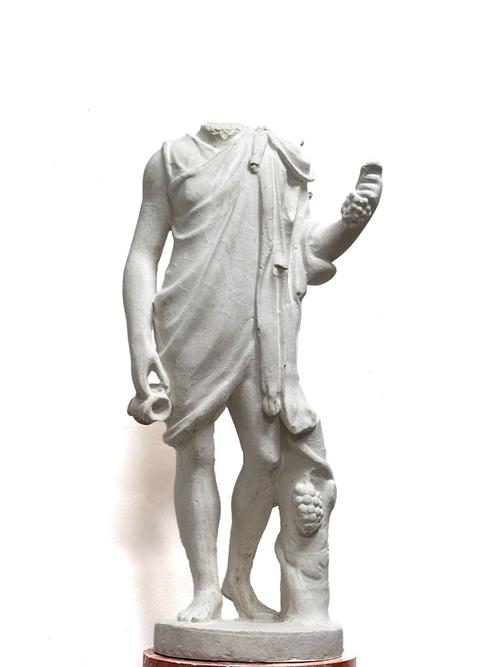 A PLASTER FIGURE AFTER THE ANTIQUE POSSIBLY DEPICTING BACCHUS OR APOLLO