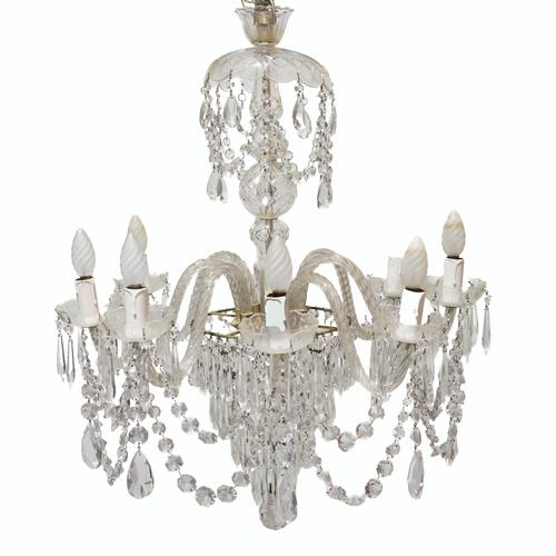 A REGENCY STYLE GLASS AND SILVERED METAL EIGHT LIGHT GLASS CHANDELIER