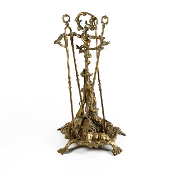 A FRENCH CAST BRASS HUNTING THEMED THREE PIECE COMPANION SET AND STAND (5)