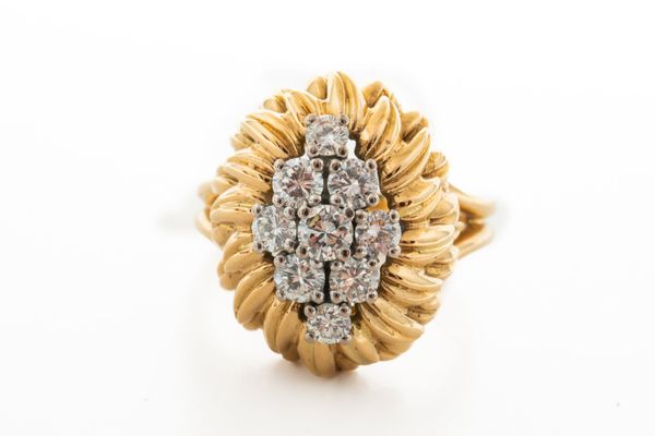 A GOLD AND DIAMOND NINE STONE CLUSTER RING