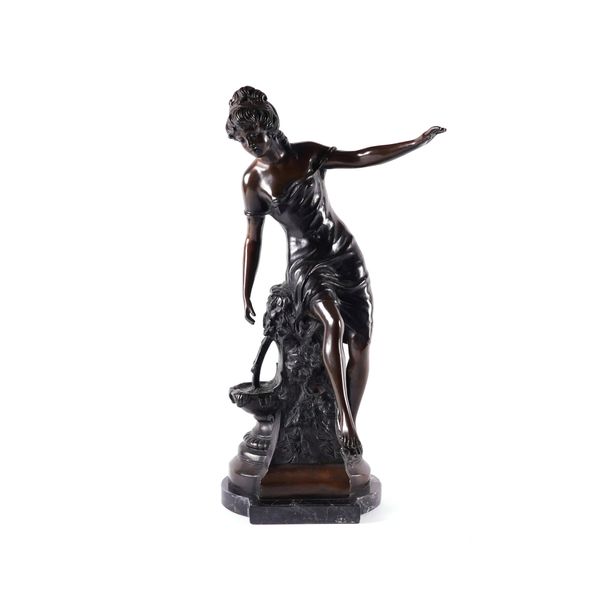 A PATINATED BRONZE SCULPTURE OF A FEMALE PERCHED ON A FOUNTAIN