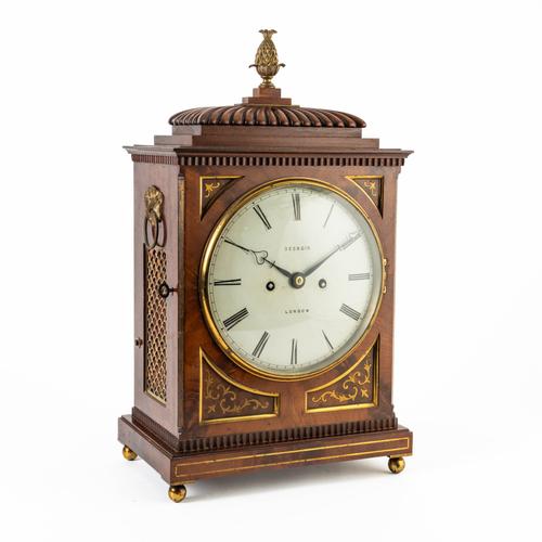 AN EDWARDIAN MAHOGANY AND BRASS INLAID STRIKING MANTEL CLOCK