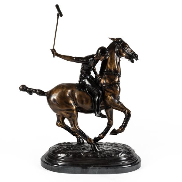 A BRONZE EFFECT CAST METAL FIGURE OF A POLO PLAYER