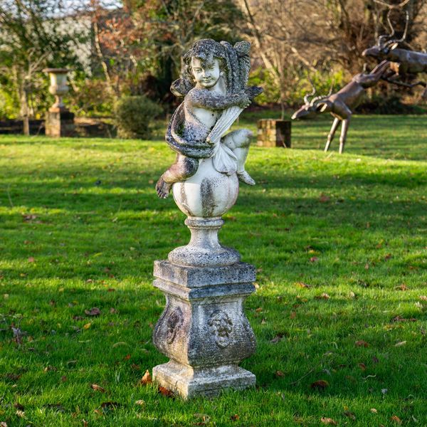 A SET OF FOUR RECONSTITUTED STONE CHERUB FIGURES (4)