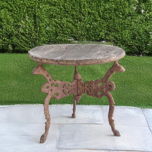 A CIRCULAR HARDWOOD GARDEN TABLE