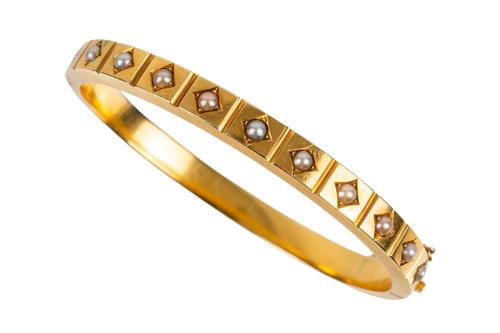 A VICTORIAN GOLD AND HALF PEARL BANGLE