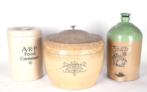 AN EARLY 20TH CENTURY STONEWARE BREAD BIN TOGETHER WITH A LIDDED STONEWARE FOOD CONTAINER AND A STONEWARE CIDER FLAGON (3)