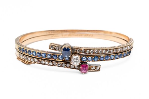 A SAPPHIRE, DIAMOND AND RUBY BANGLE