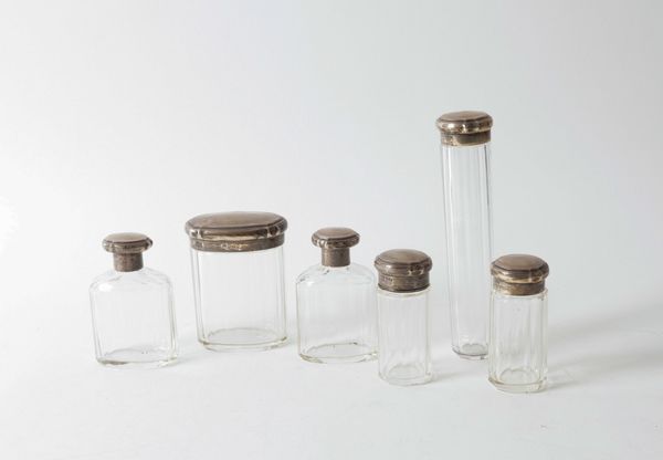 A GROUP OF SIX SILVER LIDDED TOILET BOTTLES AND JARS (6)