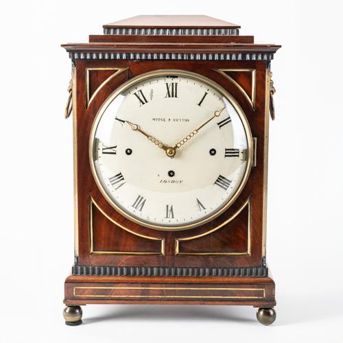 A REGENCY MAHOGANY AND BRASS-MOUNTED QUARTER STRIKING CHAMFER TOP BRACKET CLOCK
