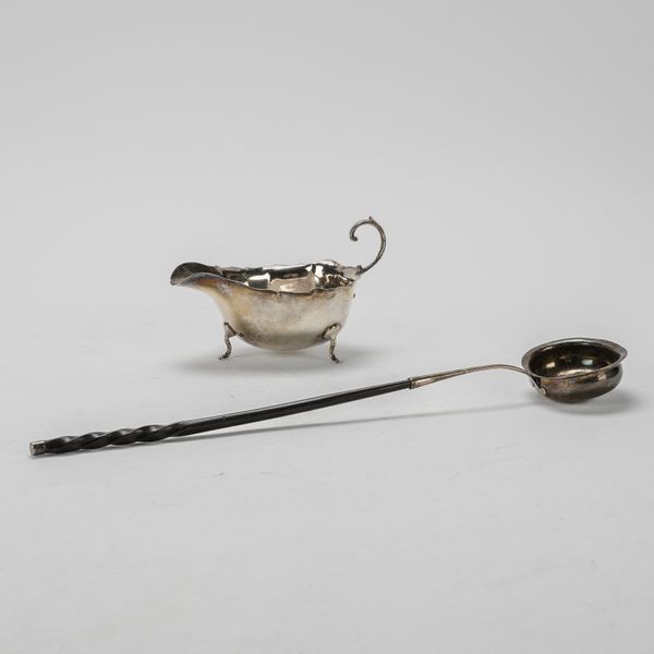 A SILVER SAUCEBOAT AND A SILVER TODDY LADLE (2)