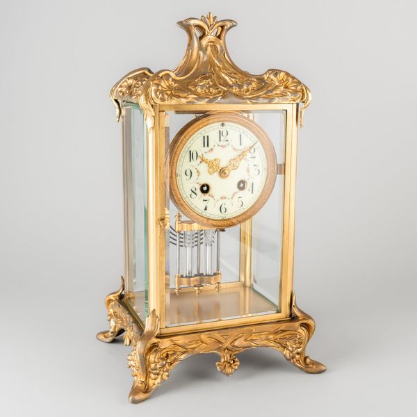 A FRENCH GILT-SPELTER AND BRASS FOUR-GLASS MANTEL CLOCK