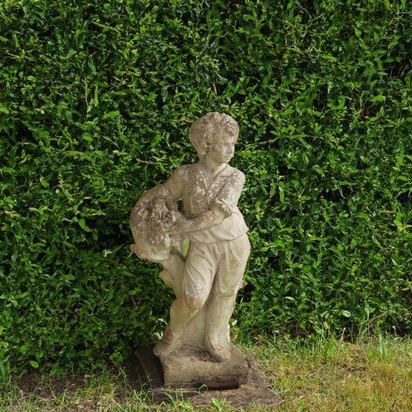 A RECONSTITUTED STONE FIGURE OF A YOUNG BOY