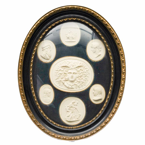 A FRAMED GROUP OF SEVEN PLASTER 'GRAND TOUR' INTAGLIONS AFTER THE ANTIQUE