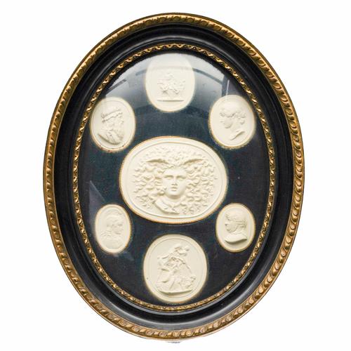 A FRAMED GROUP OF SEVEN PLASTER 'GRAND TOUR' INTAGLIONS AFTER THE ANTIQUE