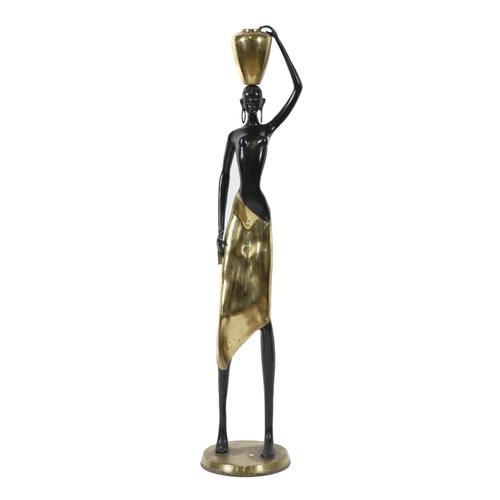 A LACQUERED BRASS AND PATINATED METAL FIGURE OF AN AFRICAN WATER CARRIER, POSSIBLY OF THE NDEBELE TRIBE